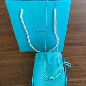 New- Tiffany & Co. T smile necklace.
